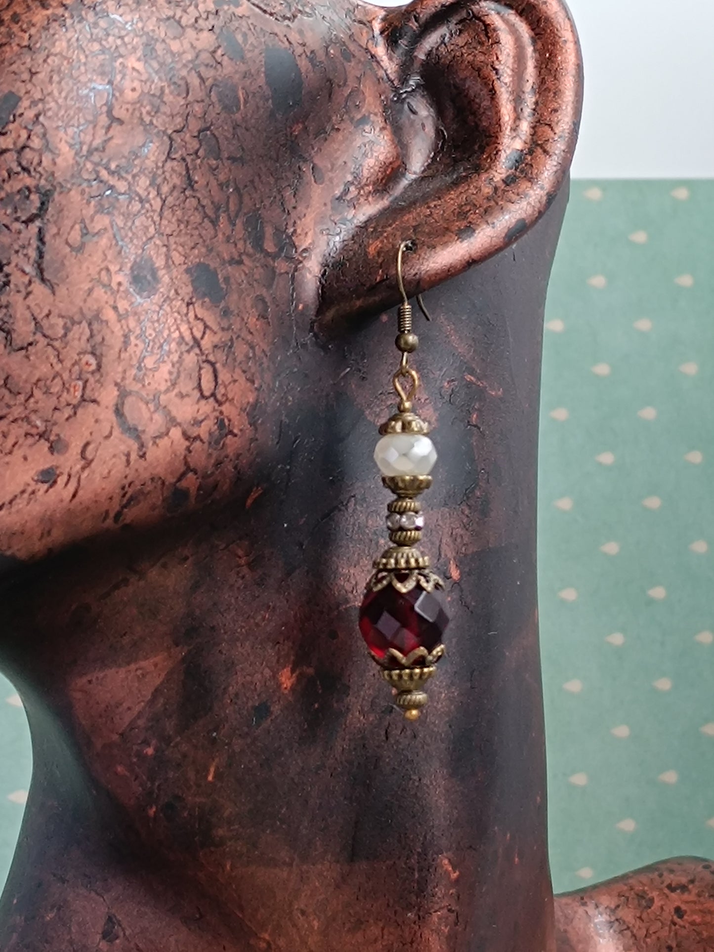 Boucles d'oreilles pendantes artisanales – Perles facettées rouges et blanches, métal bronze antique filigrané