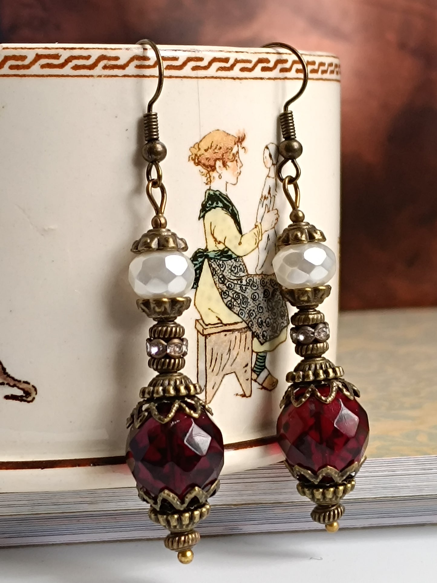 Boucles d'oreilles pendantes artisanales – Perles facettées rouges et blanches, métal bronze antique filigrané