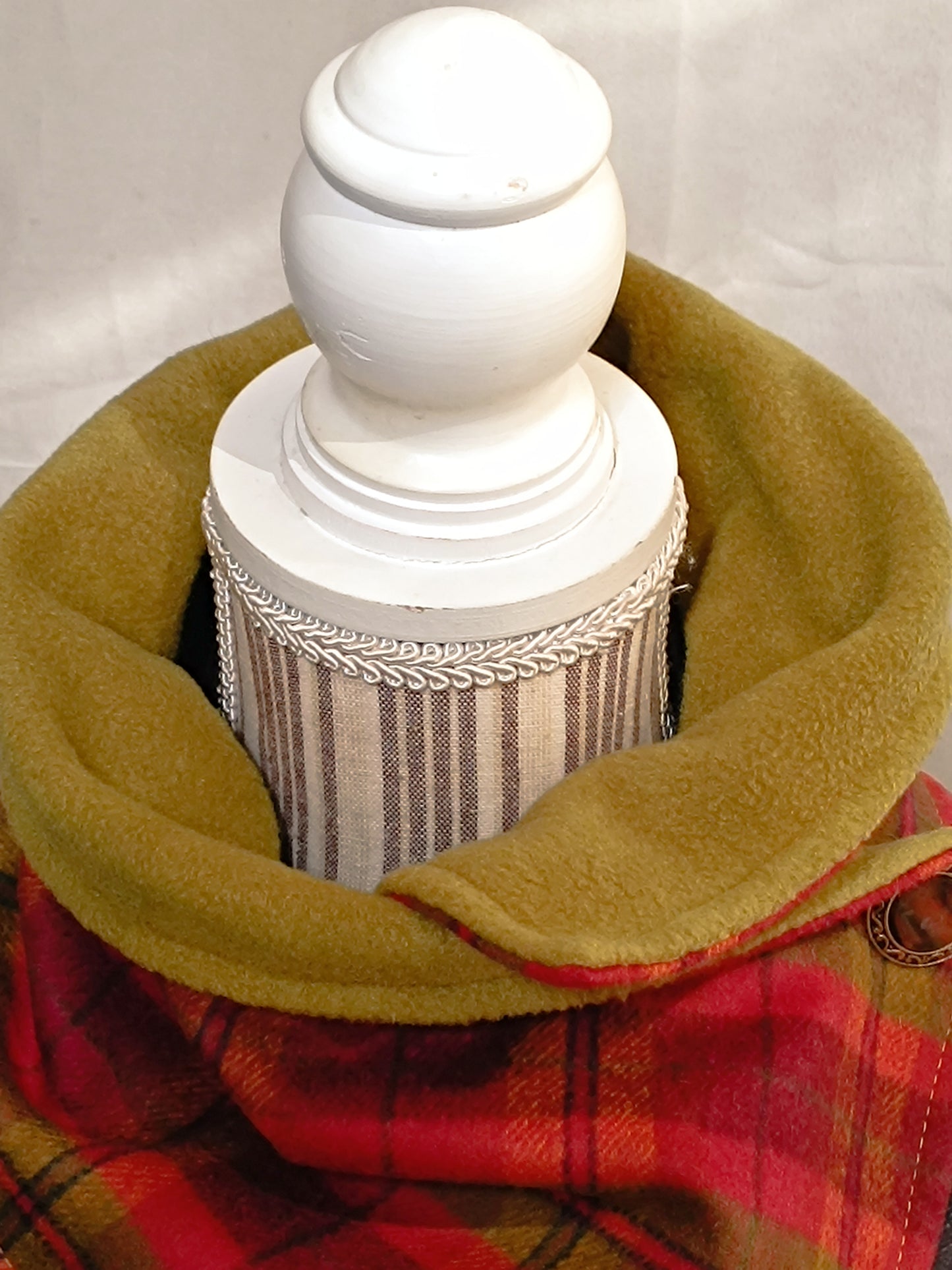 Tour de cou artisanal en laine grattée tartan rouge et vert, doublé polaire moutarde ultra douce. Accessoire textile d’hiver alliant chaleur enveloppante et pureté visuelle, idéal pour briser les codes bourgeois de l’accessoire tout en affirmant sa présence avec élégance.